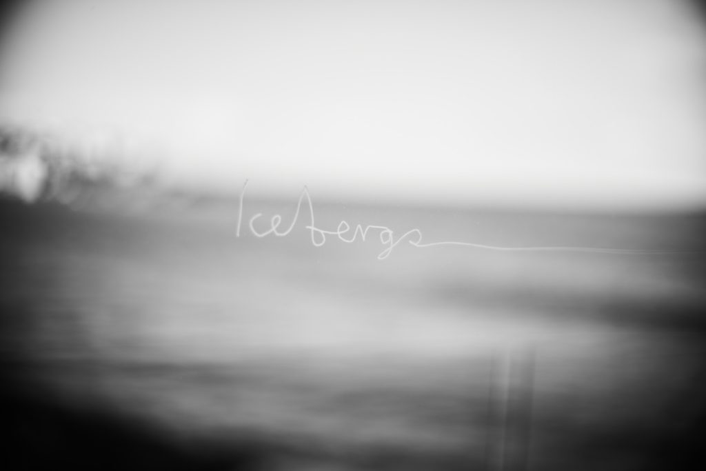 Blurred black and white image of the Icebergs name