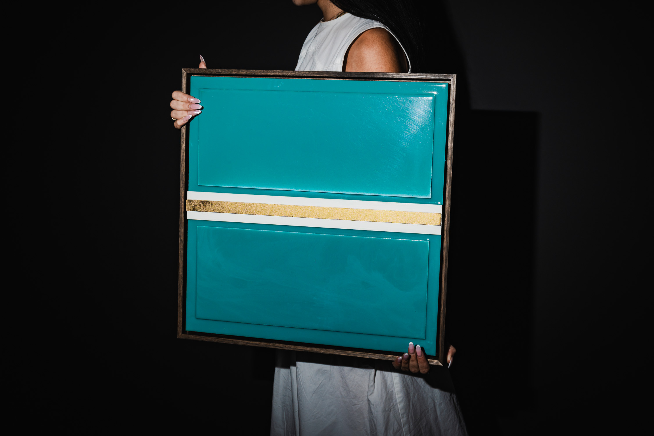 Person holding the teal City of Gold print
