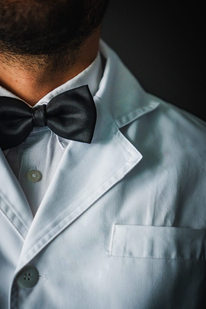 Man in a white dinner jacket and bow tie