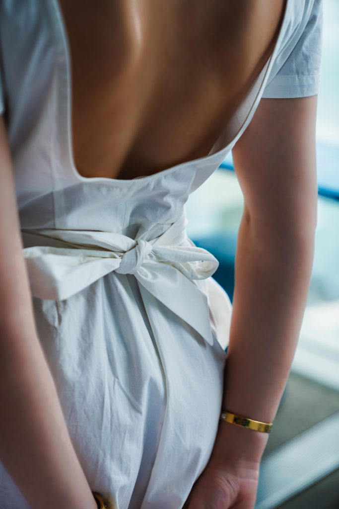 Back view of a guest in a white bow dress