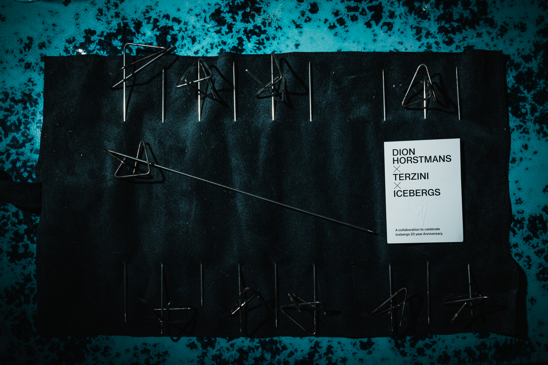 BBQ skewers arranged on a dark board with a product card