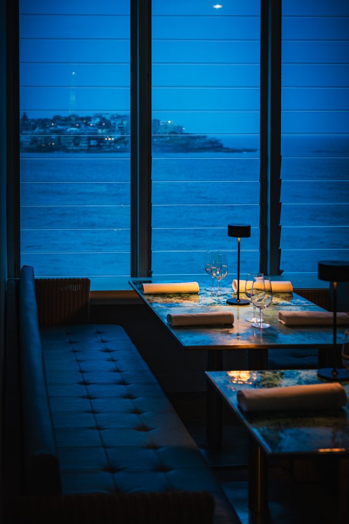 Icebergs dining room in the evening overlooking Bondi's lights