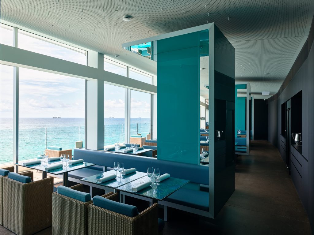 Icebergs dining room with blue banquettes and ocean views