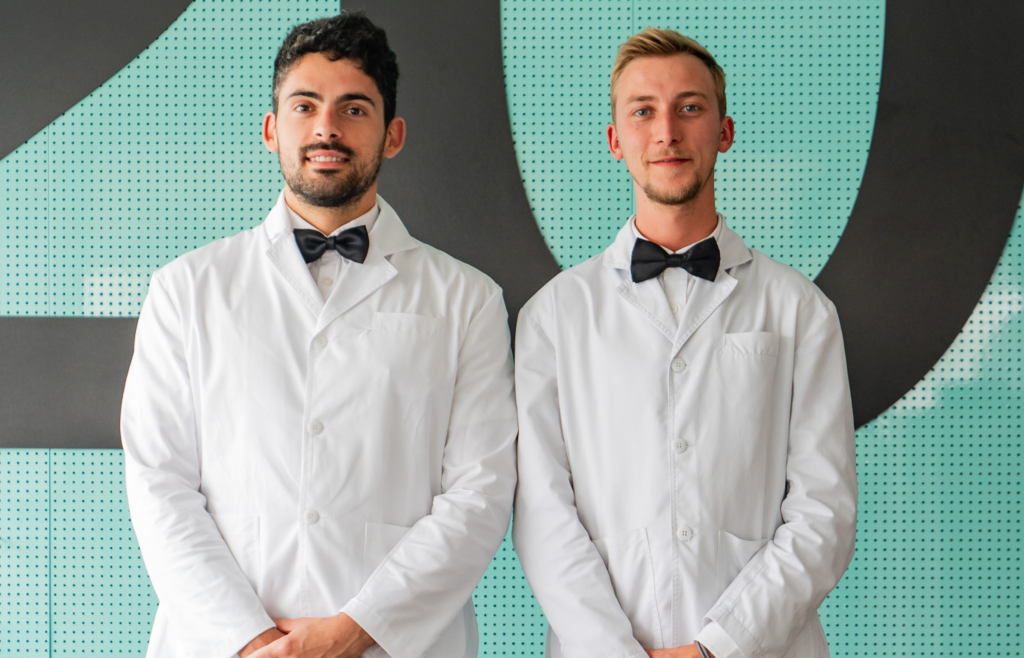 Two Icebergs waiters in white jackets and black bow ties