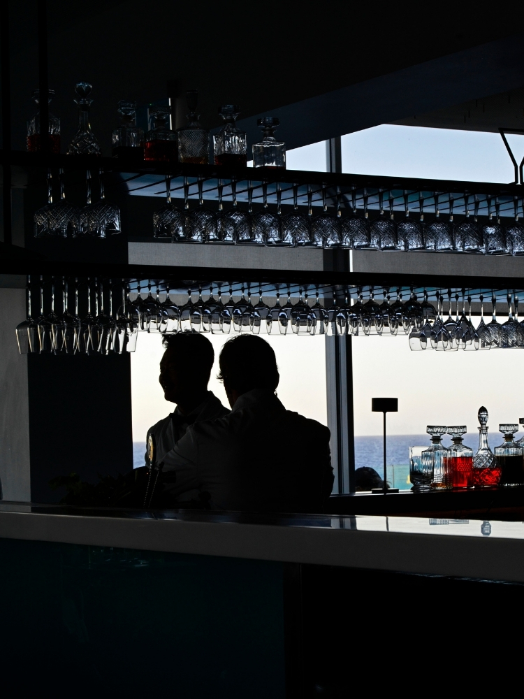 Icebergs Bar interior with glassware hanging above the counter