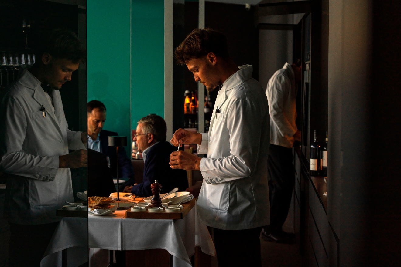 Icebergs waiters serving guests at a dining room table