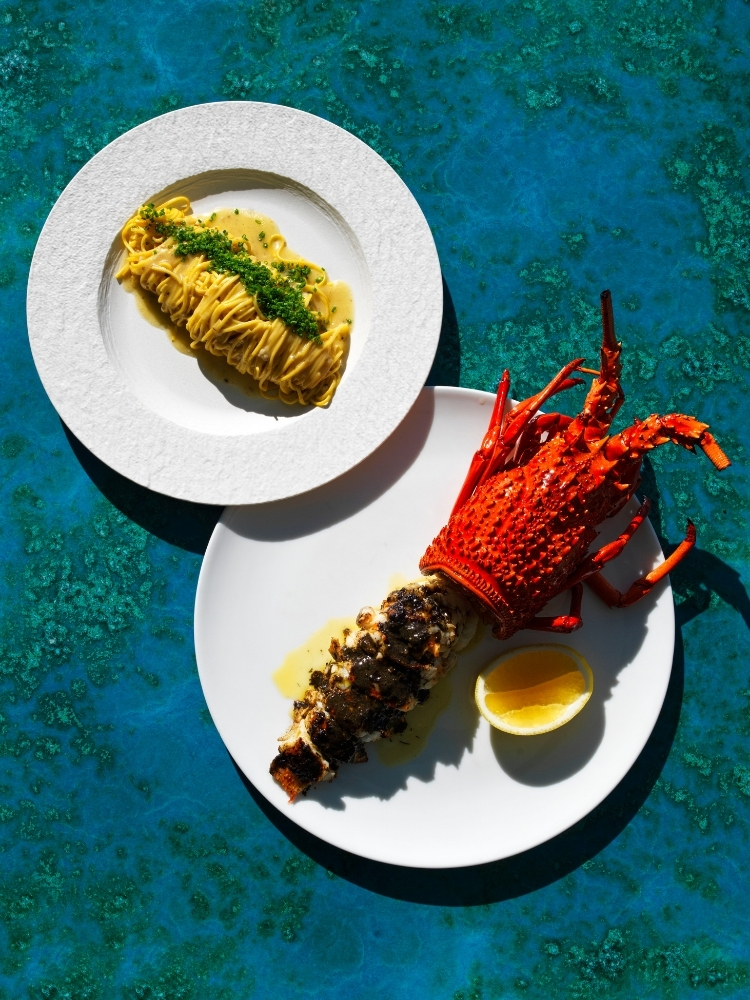 Lobster and a second plated dish served on white plates