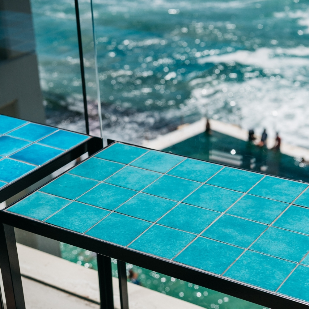 Teal tiled balcony table above the Bondi ocean pool